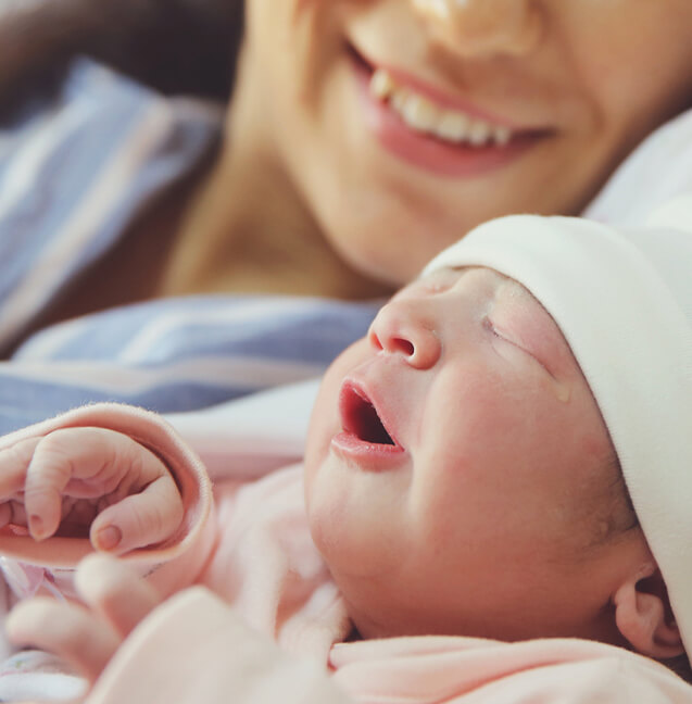 close up of mother next to her newborn