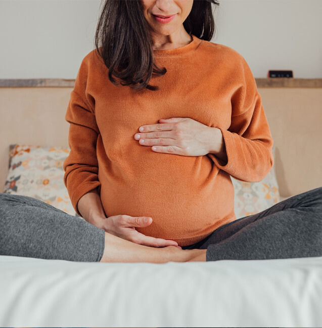 pregnant woman touching her belly