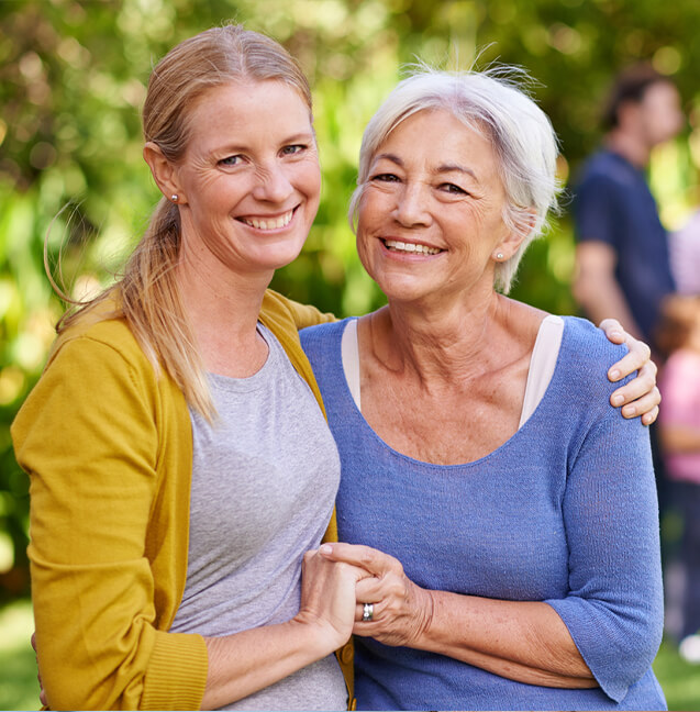 woman next to her mother smiling