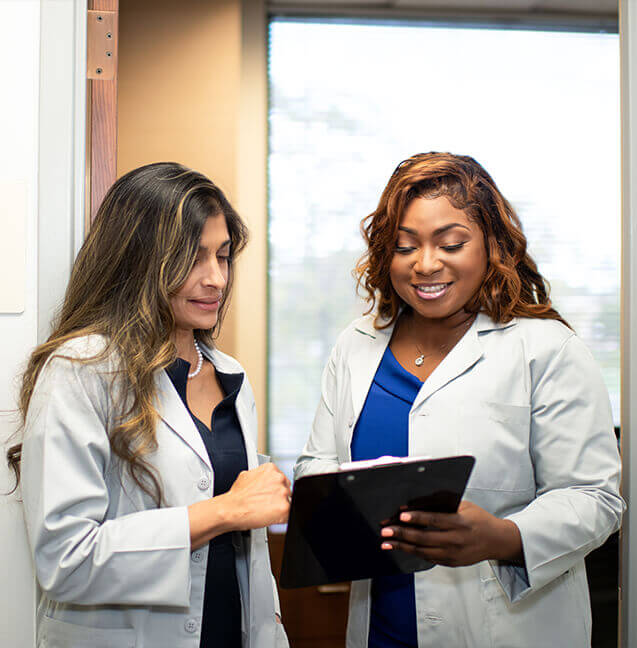 two obgyn doctors looking at patient's chart